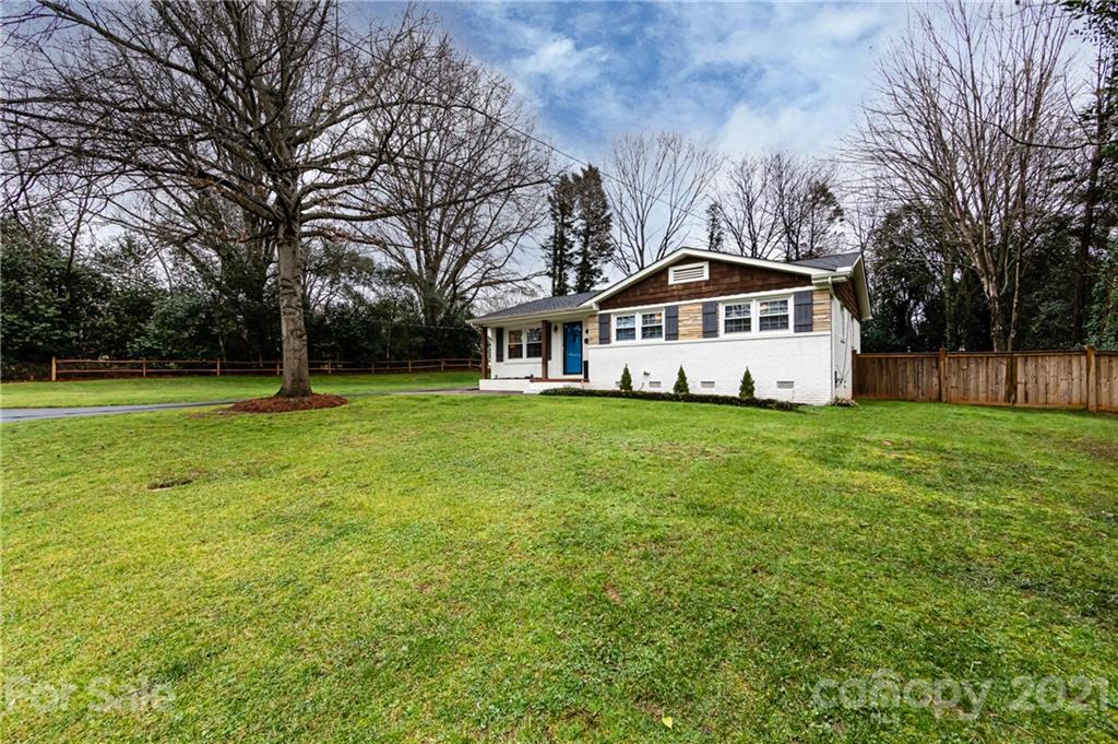 1417 Burnley Road Charlotte, NC 28210 - Photo 3 of 43 a white house with a big yard and large trees