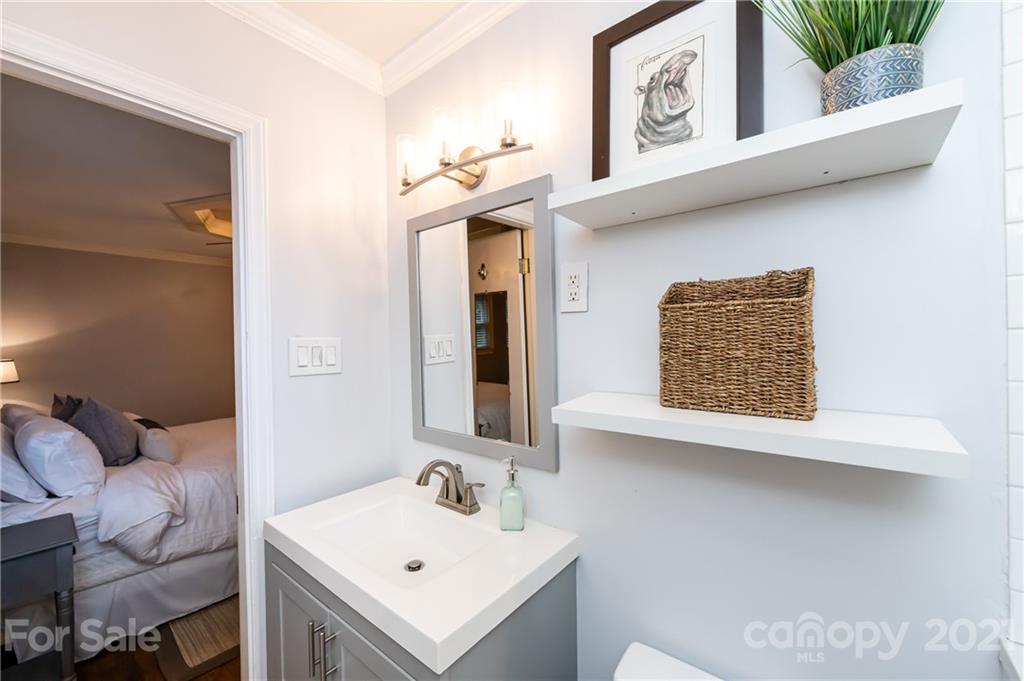 1417 Burnley Road Charlotte, NC 28210 - Photo 24 of 43 a bathroom with a sink and a mirror