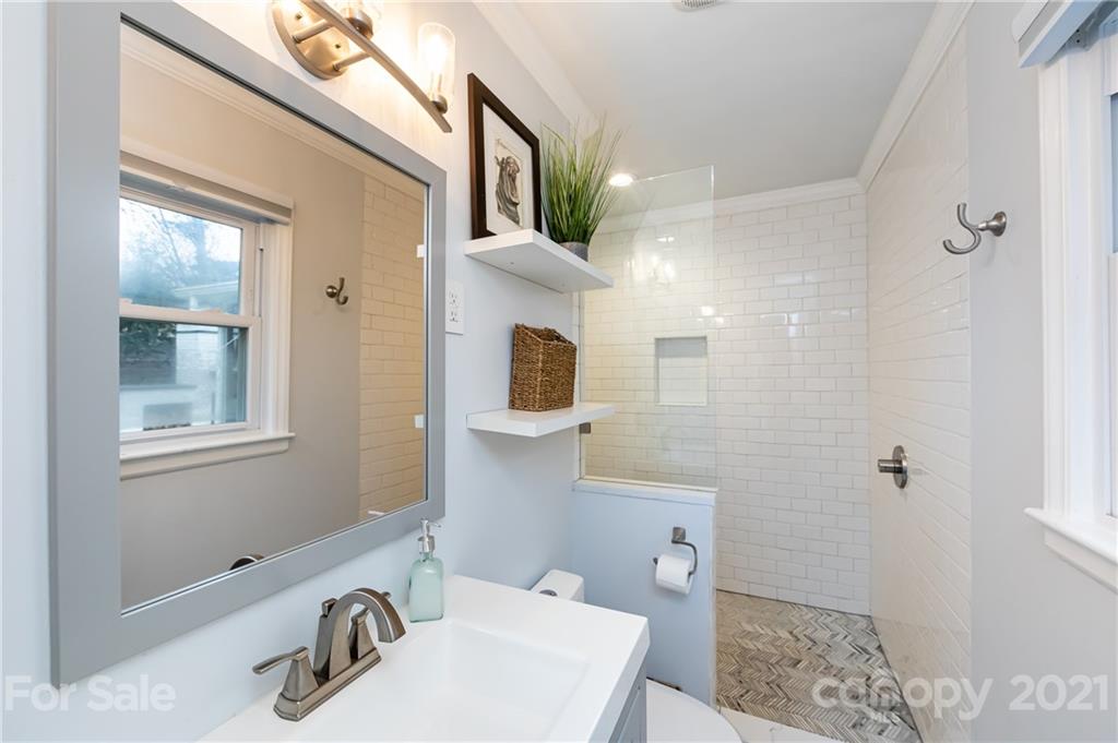 1417 Burnley Road Charlotte, NC 28210 - Photo 25 of 43 a bathroom with a sink a toilet and shower