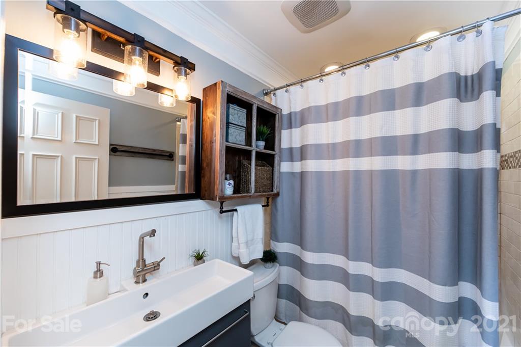 1417 Burnley Road Charlotte, NC 28210 - Photo 29 of 43 a bathroom with a sink and a mirror