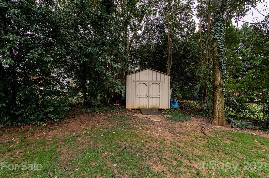 1417 Burnley Road Charlotte, NC 28210 - Photo 36 of 43 a view of a barn in the middle of a forest