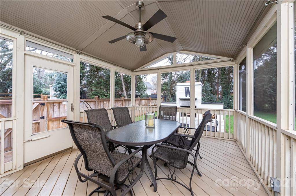 1417 Burnley Road Charlotte, NC 28210 - Photo 40 of 43 a dining room with furniture large windows and a chandelier