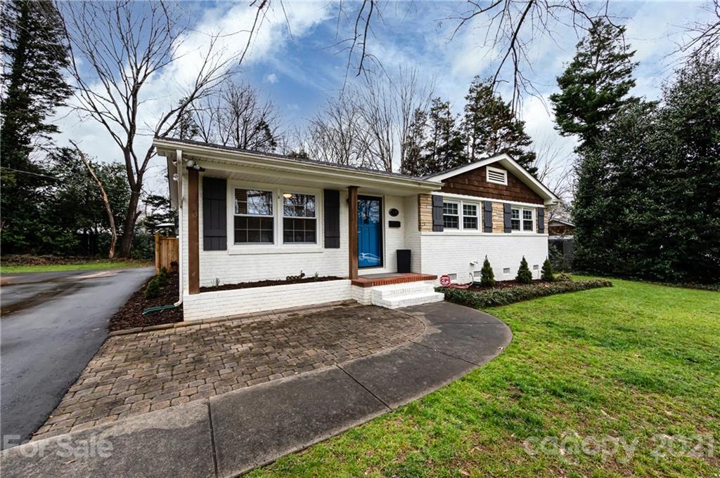1417 Burnley Road Charlotte, NC 28210 - Photo 5 of 43 a front view of a house with a yard and garage