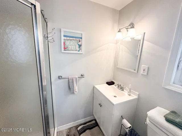 a bathroom with a sink mirror and toilet