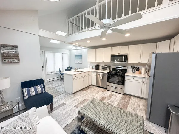 a kitchen with a refrigerator and a stove top oven