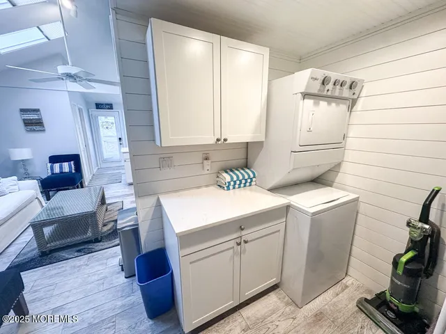 a utility room with cabinets washer and dryer