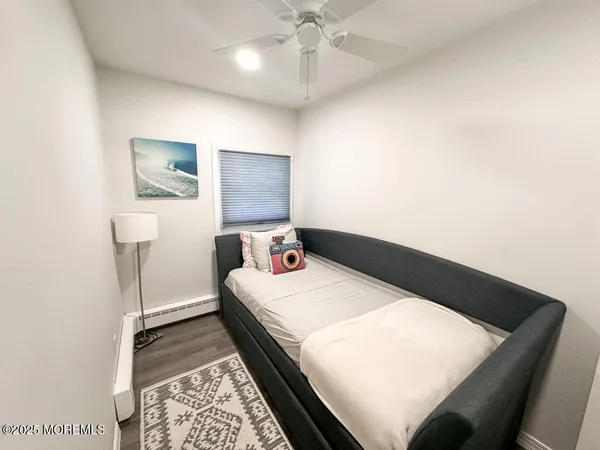 a bedroom with a bed and a wall painting