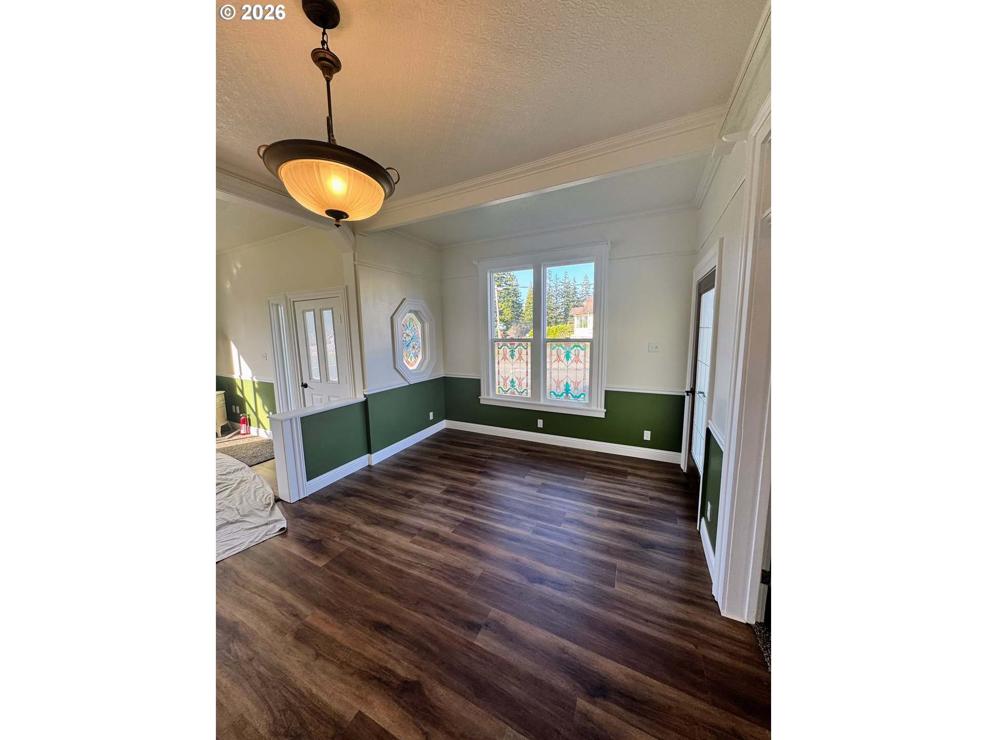 584 North Baxter Street Coquille, OR 97423 - Photo 5 of 39 a view of an empty room with wooden floor and a window
