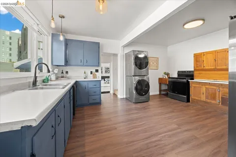 a kitchen with kitchen island a sink cabinets and wooden floor