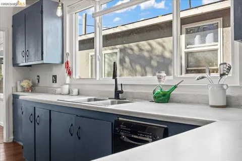 a kitchen with granite countertop a sink and a window