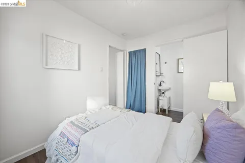 a bedroom with a bed and a lamp