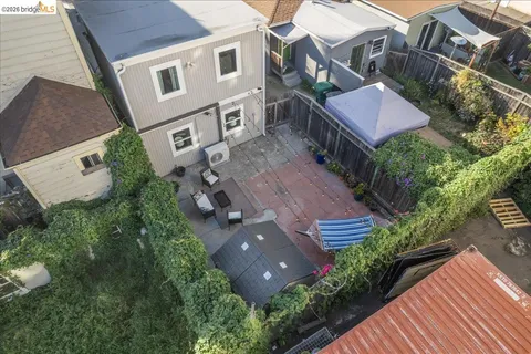 an aerial view of multiple houses with a yard