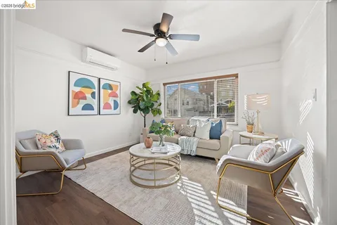 a living room with furniture a rug and a chandelier
