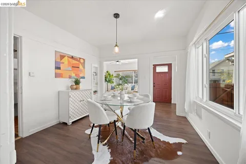a view of a dining room with furniture window and wooden floor