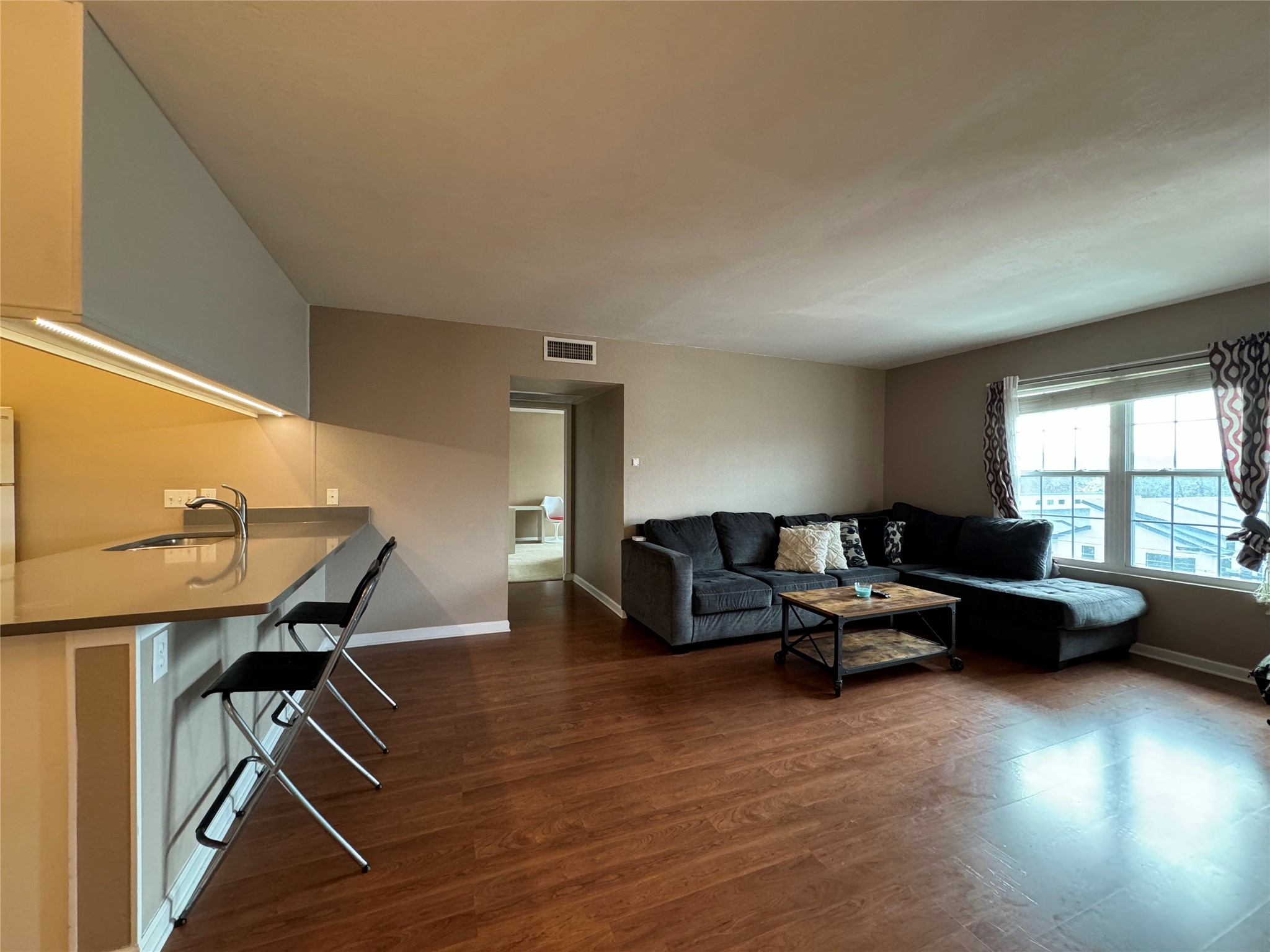 910 Duncan Lane, Unit 43 Austin, TX 78705 - Photo 1 of 15 a living room with furniture and a wooden floor