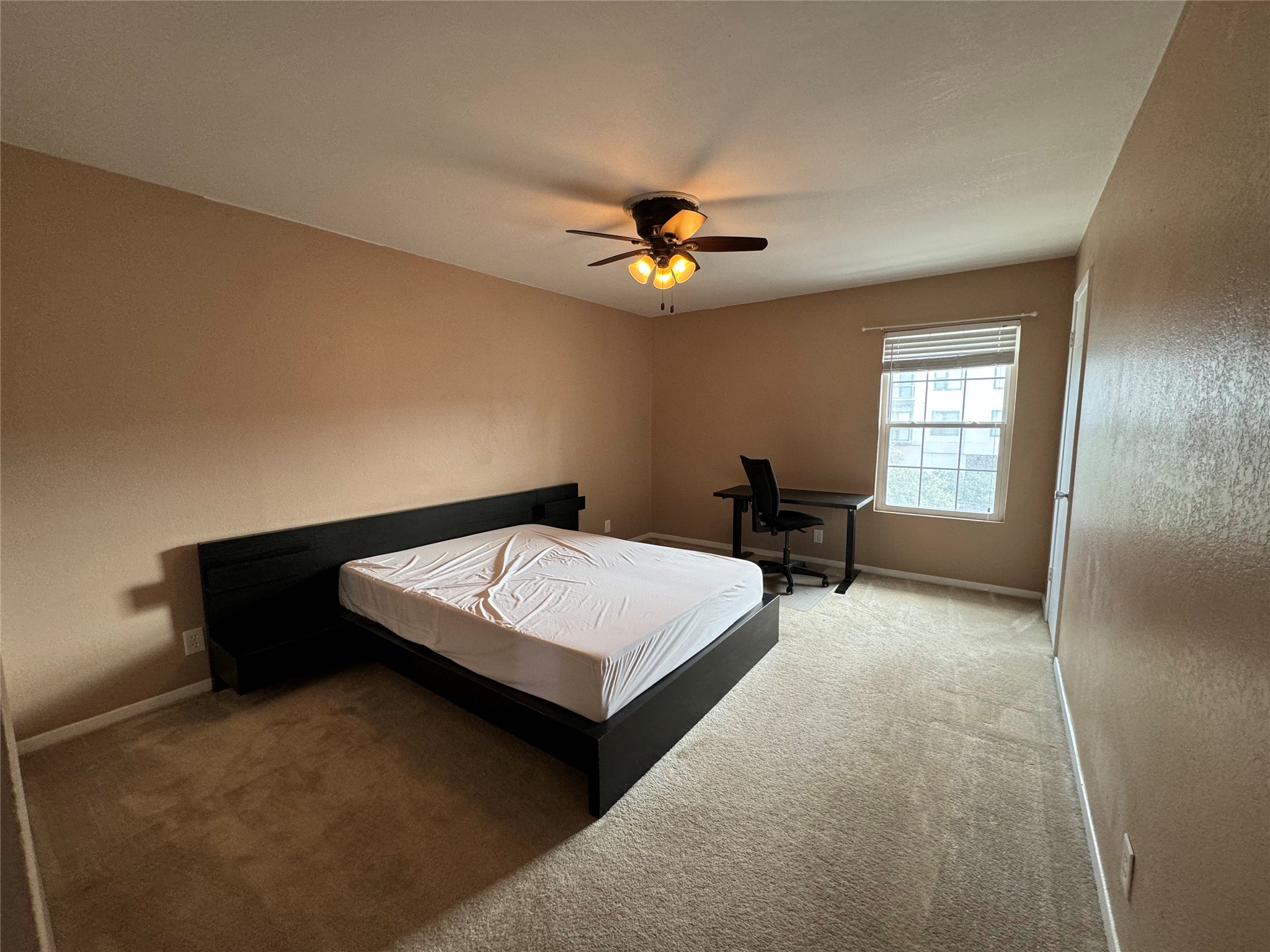 910 Duncan Lane, Unit 43 Austin, TX 78705 - Photo 4 of 15 a spacious bedroom with a bed and window