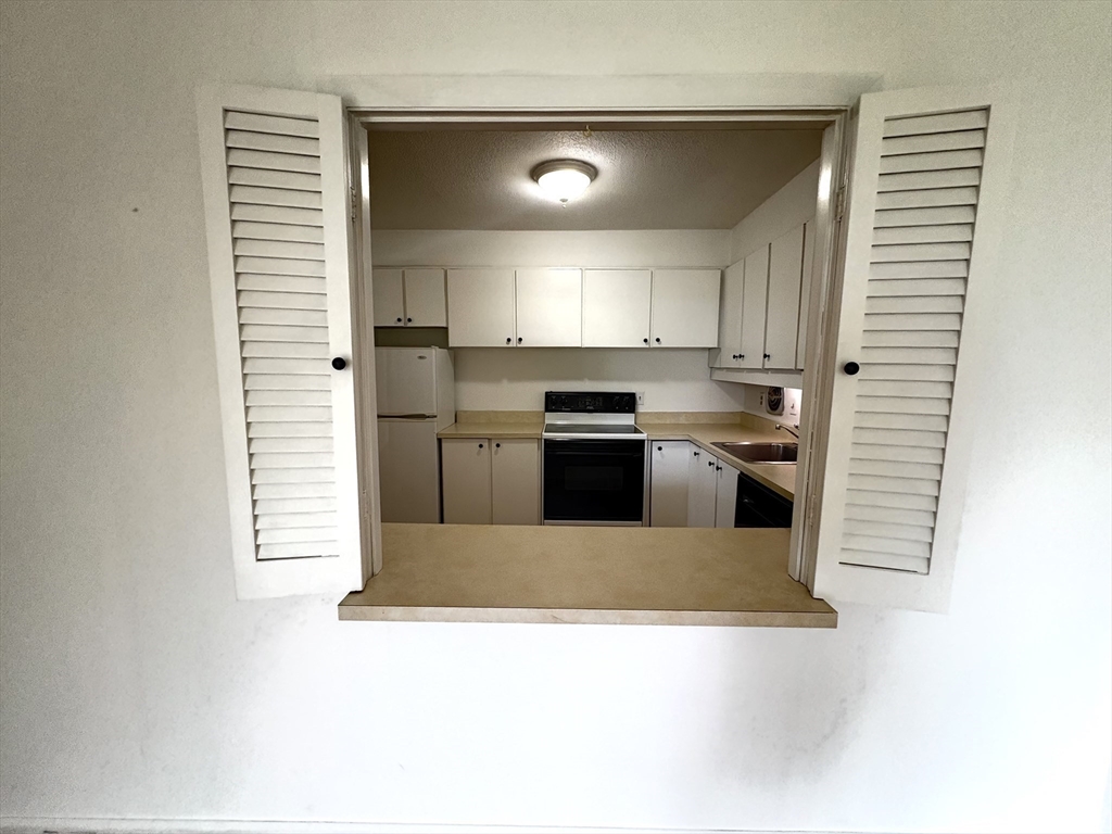 80 Salisbury Street, Unit 308 Worcester, MA 01609 - Photo 18 of 25 a kitchen with stainless steel appliances granite countertop a refrigerator and a sink