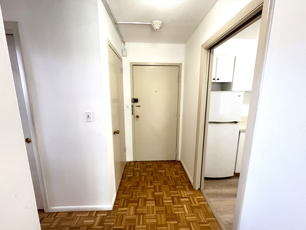 80 Salisbury Street, Unit 308 Worcester, MA 01609 - Photo 19 of 25 a view of a hallway with wooden floor and a bathroom