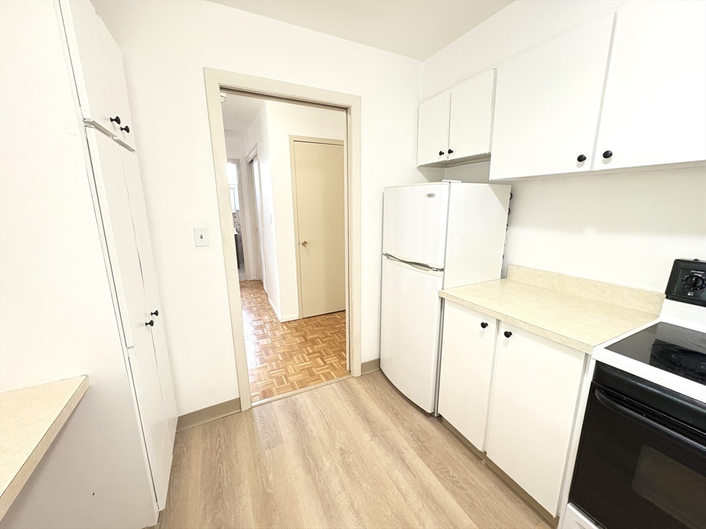 80 Salisbury Street, Unit 308 Worcester, MA 01609 - Photo 10 of 25 a view of kitchen with refrigerator and cabinets