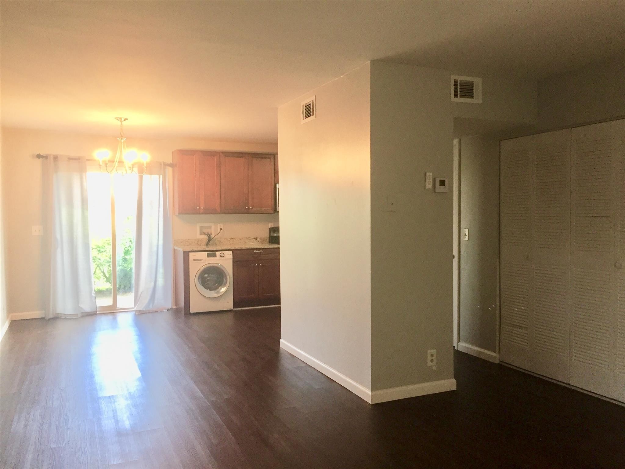 370 Wallace Road, Unit F9 Nashville, TN 37211 - Photo 4 of 14 a view of a kitchen with a fridge wooden floor and a window