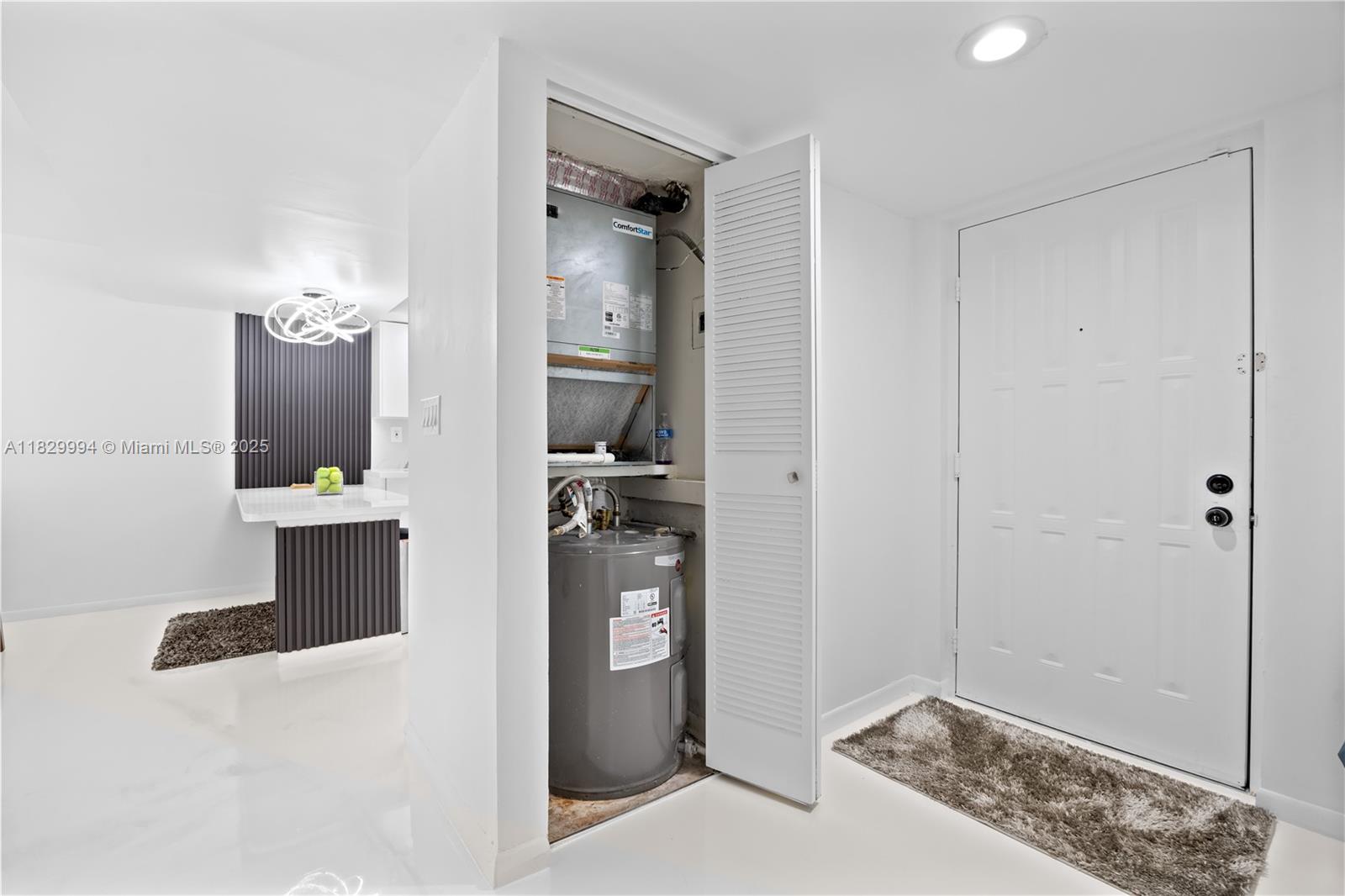 8810 Southwest 132nd Place, Unit 101DN Miami, FL 33186 - Photo 13 of 39 a view of a hallway with a livingroom and a bathroom with sink