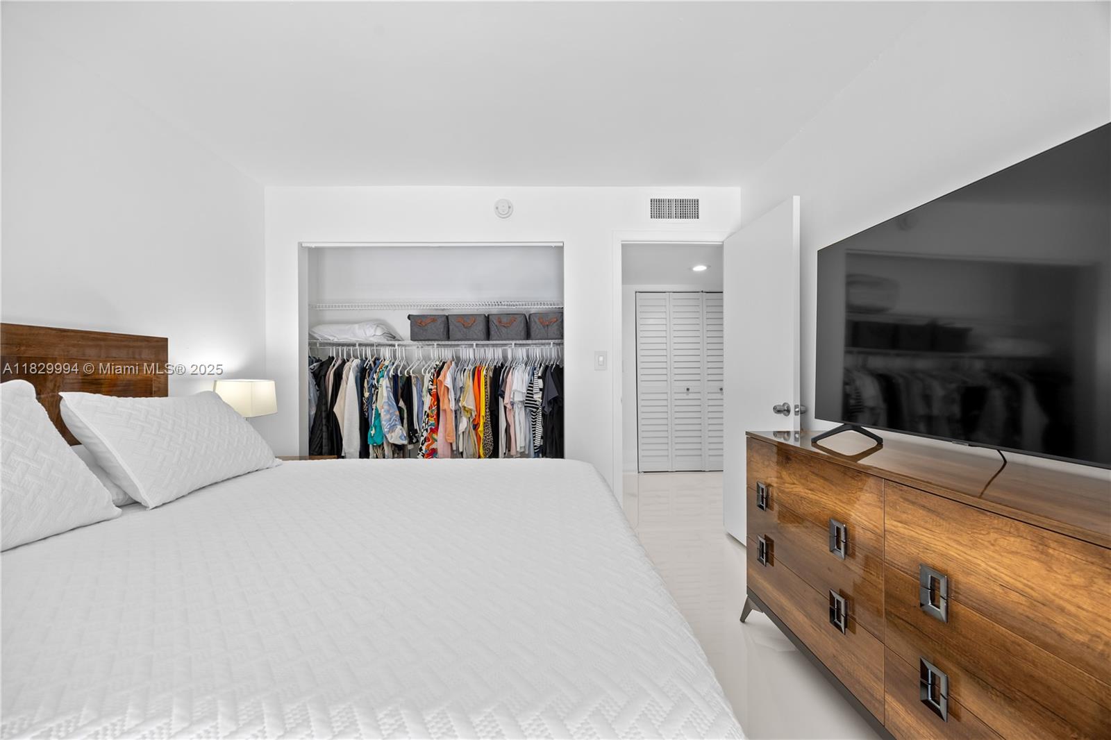 8810 Southwest 132nd Place, Unit 101DN Miami, FL 33186 - Photo 15 of 39 a bed room with a bed and a television