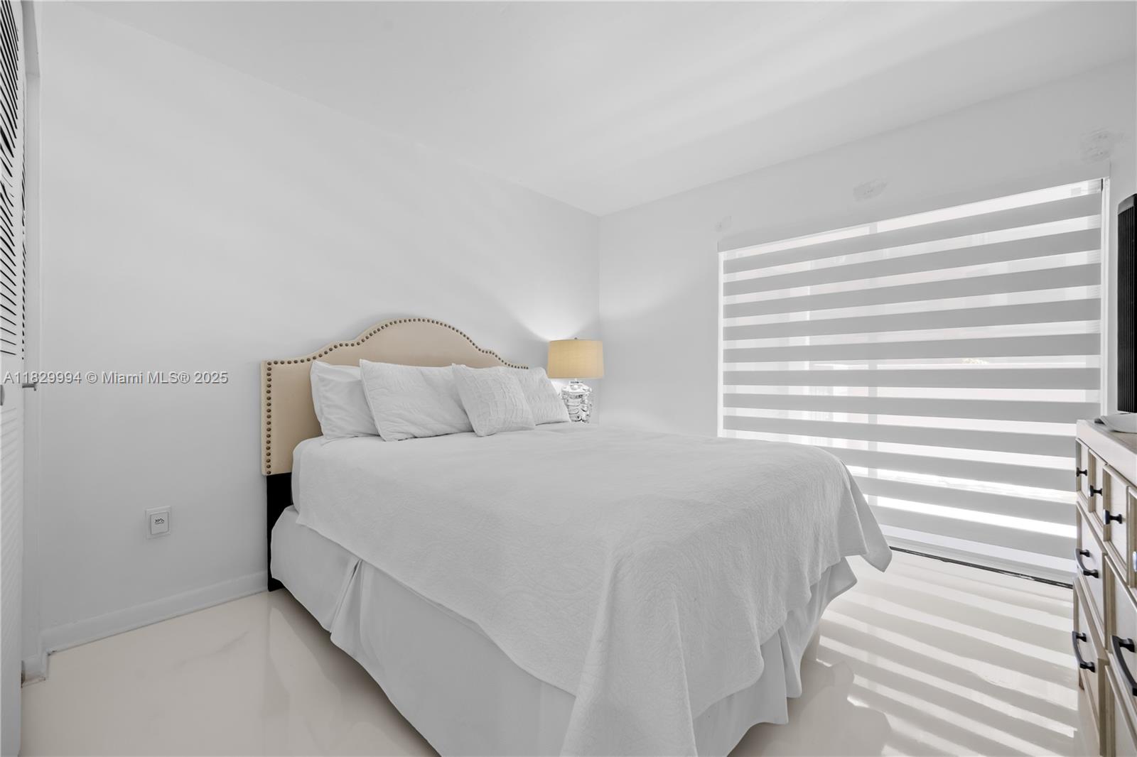 8810 Southwest 132nd Place, Unit 101DN Miami, FL 33186 - Photo 17 of 39 a bedroom with a bed and a window