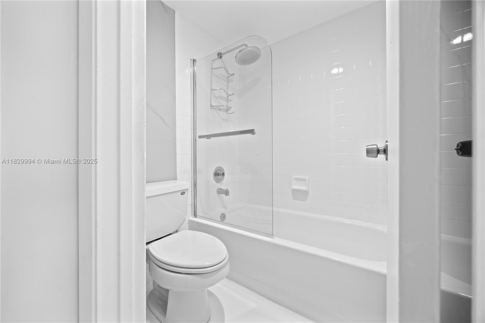 8810 Southwest 132nd Place, Unit 101DN Miami, FL 33186 - Photo 23 of 39 a bathroom with a toilet and a shower