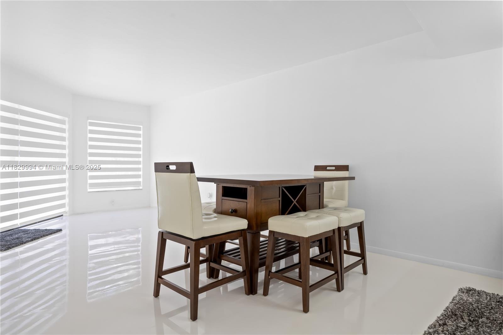 8810 Southwest 132nd Place, Unit 101DN Miami, FL 33186 - Photo 24 of 39 a view of a dining room with furniture and a window
