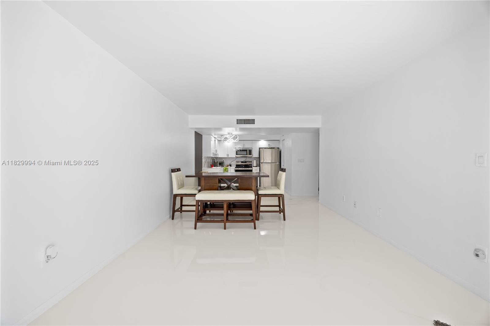 8810 Southwest 132nd Place, Unit 101DN Miami, FL 33186 - Photo 27 of 39 a view of a room with a table and chairs