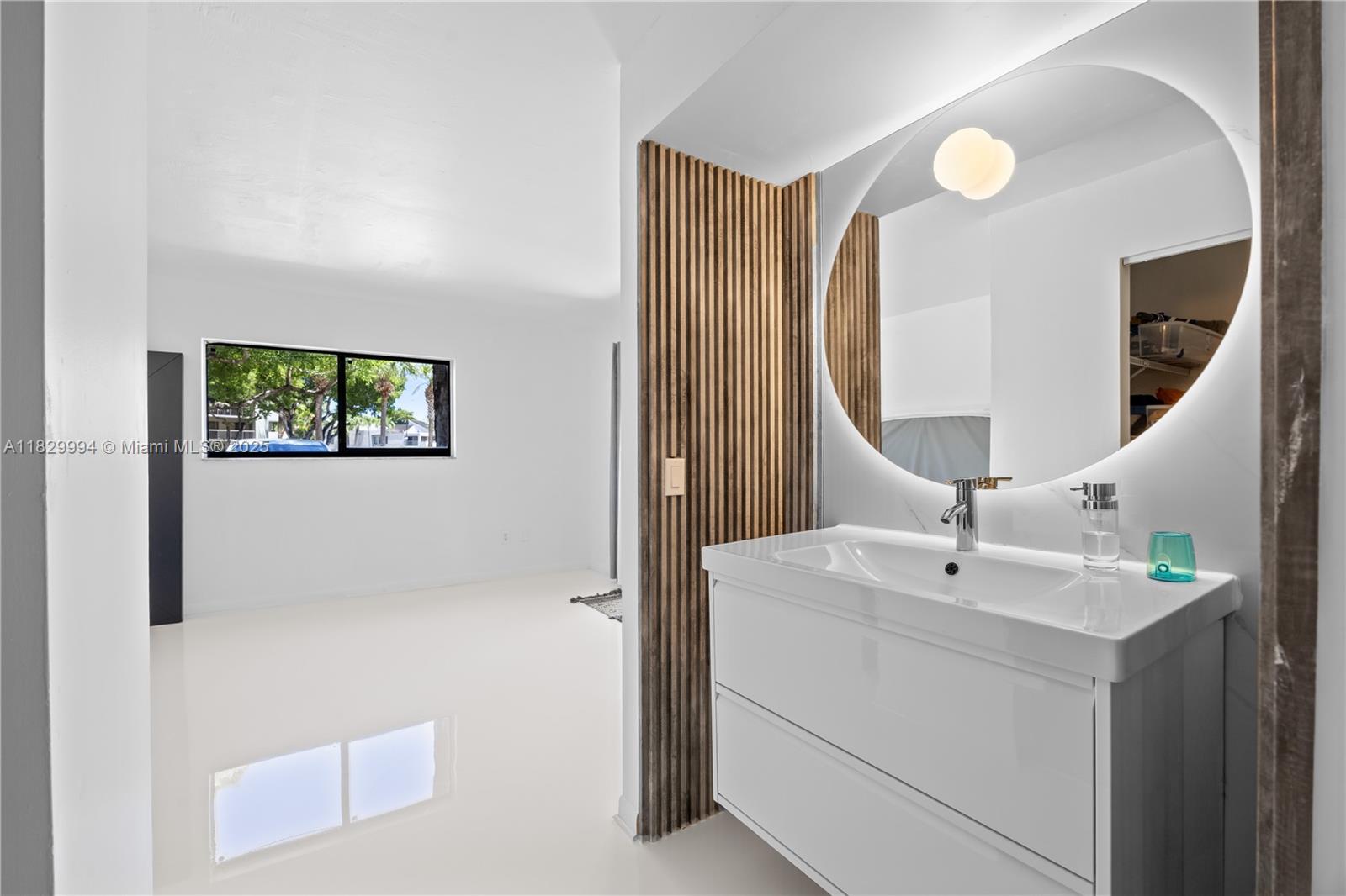 8810 Southwest 132nd Place, Unit 101DN Miami, FL 33186 - Photo 3 of 39 a bathroom with a sink and a mirror