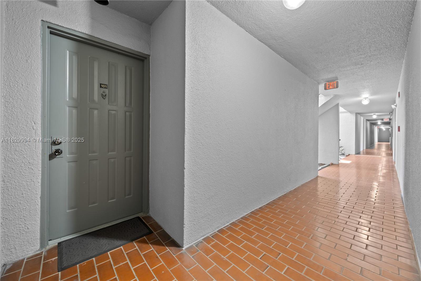8810 Southwest 132nd Place, Unit 101DN Miami, FL 33186 - Photo 31 of 39 a view of a hallway with wooden floor and a bathroom
