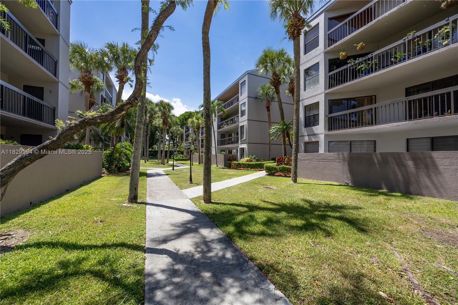 8810 Southwest 132nd Place, Unit 101DN Miami, FL 33186 - Photo 32 of 39 a view of a building with a yard