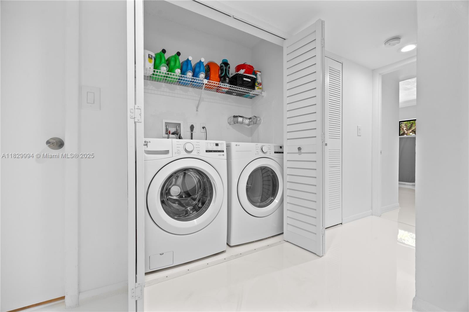 8810 Southwest 132nd Place, Unit 101DN Miami, FL 33186 - Photo 5 of 39 a utility room with dryer and washer
