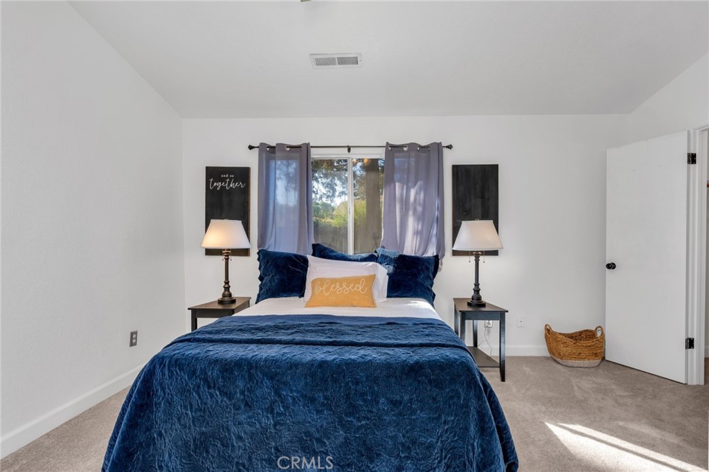 848 Lehigh Drive Merced, CA 95348 - Photo 14 of 30 a bedroom with a bed and a lamp