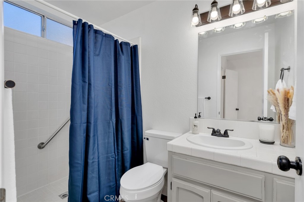 848 Lehigh Drive Merced, CA 95348 - Photo 17 of 30 a bathroom with a sink a toilet and shower