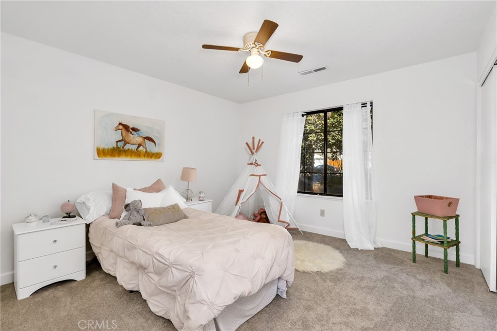 848 Lehigh Drive Merced, CA 95348 - Photo 21 of 30 a bedroom with a bed and a chandelier