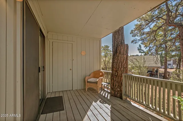 a view of a balcony with furniture and wooden floor
