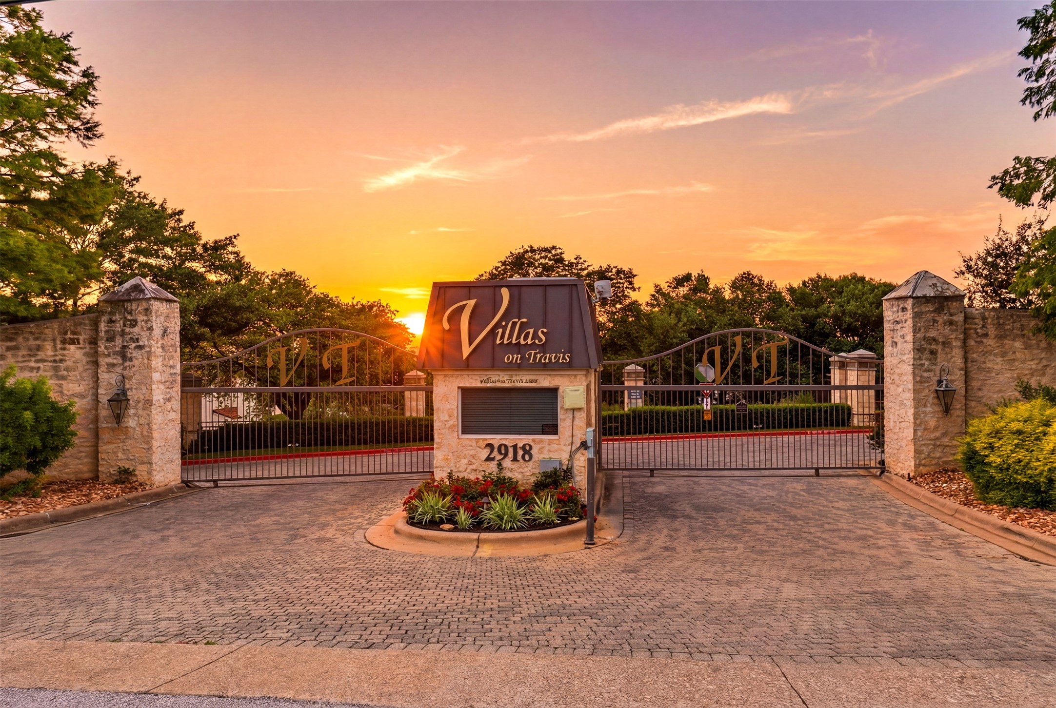 2918 Ranch Road 620, Unit 265 Austin, TX 78734 - Photo 4 of 40 Secure entry to a charming community, framed by stone columns and an inspiring sunset.