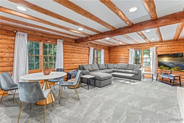 a kitchen with stainless steel appliances granite countertop a refrigerator a sink dishwasher a stove with wooden cabinets and floor