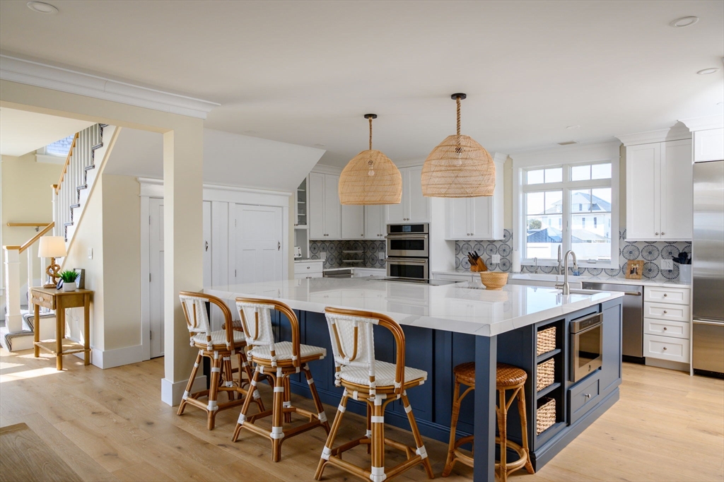 133 Beach Avenue Hull, MA 02045 - Photo 11 of 42 a large kitchen with a table chairs and refrigerator