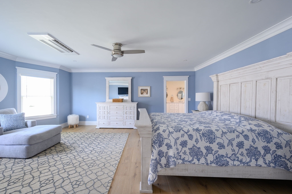 133 Beach Avenue Hull, MA 02045 - Photo 16 of 42 a bedroom with a large bed and a couch