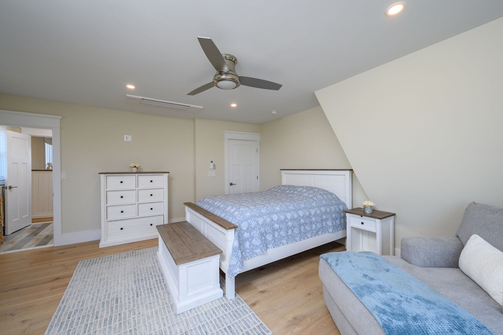 133 Beach Avenue Hull, MA 02045 - Photo 22 of 42 a bedroom with a bed and painting on the wall
