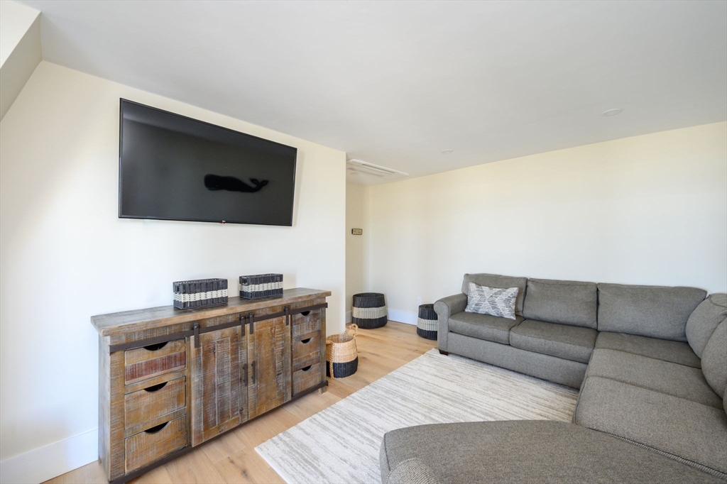 133 Beach Avenue Hull, MA 02045 - Photo 24 of 42 a living room with furniture and a flat screen tv