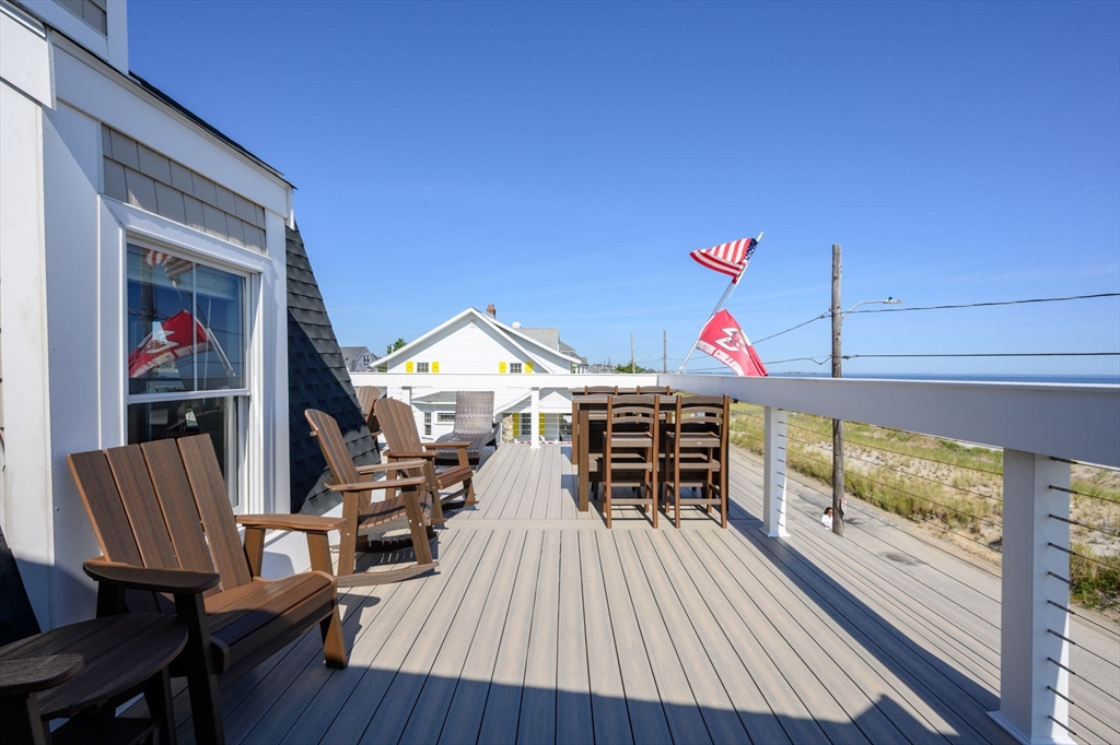 133 Beach Avenue Hull, MA 02045 - Photo 27 of 42 a view of a balcony with chairs and wooden floor