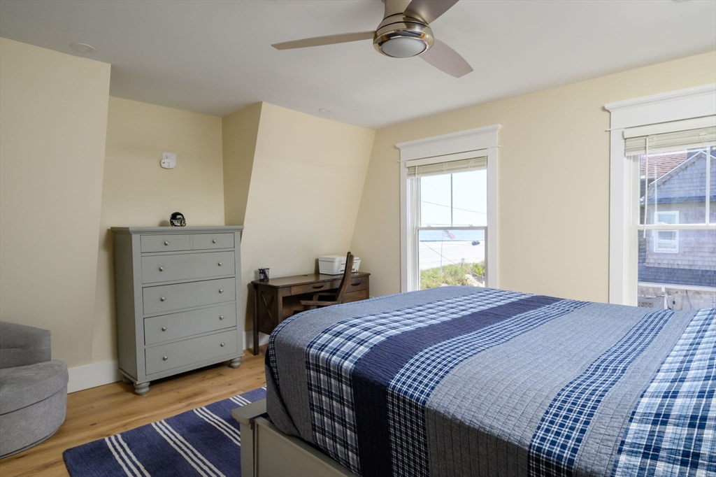133 Beach Avenue Hull, MA 02045 - Photo 32 of 42 a bedroom with a bed and a dresser