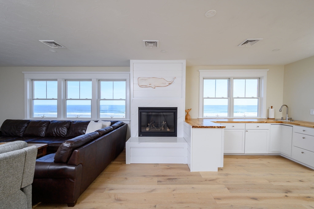 133 Beach Avenue Hull, MA 02045 - Photo 33 of 42 a living room with furniture window and a fireplace