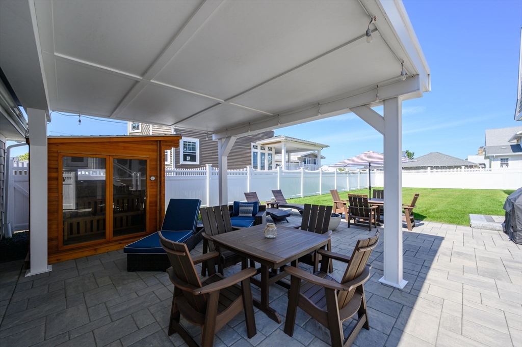 133 Beach Avenue Hull, MA 02045 - Photo 34 of 42 a view of a patio with a dining table and chairs