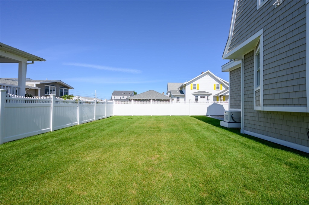 133 Beach Avenue Hull, MA 02045 - Photo 35 of 42 a house with green field in front of it