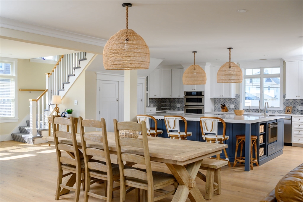 133 Beach Avenue Hull, MA 02045 - Photo 8 of 42 a room with stainless steel appliances kitchen island granite countertop a table chairs and a wooden floor